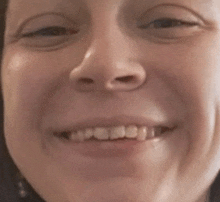 a close up of a woman 's face smiling