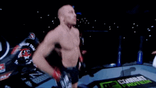 a man is standing in a boxing ring with a sign that says combat protein