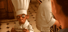 a man in a chef 's hat looks at another man in a white shirt