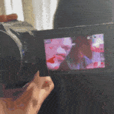 a person taking a picture with a camera that says ' nc ' on the screen