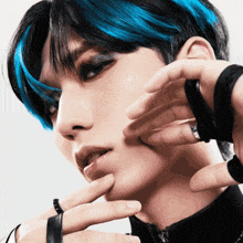 a close up of a person with black and blue hair