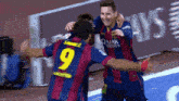 two soccer players wearing qatar airways jerseys are hugging