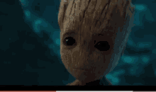 a baby groot from guardians of the galaxy is looking at the camera .