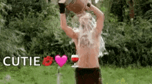 a shirtless man is holding a bucket of water over his head while holding a glass of wine .
