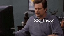 a man with a mustache is looking at a computer screen with the words ss fawz written on it