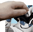 a close up of a person 's hand holding a piece of paper over a cartoon character 's face .