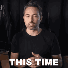 a man in a black t-shirt says this time