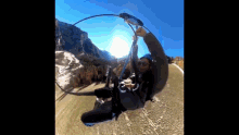 a man is flying through the air while wearing a helmet and sunglasses