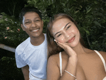a man and woman are posing for a picture and the woman is wearing a bracelet