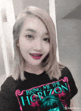 a girl with braces on her teeth is wearing a black shirt that says bring me the horizon