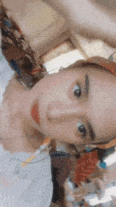 a woman wearing a hat is taking a selfie