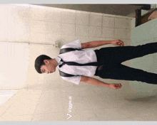a man in a white shirt and black tie is standing in a bathroom with the words veggie.ai below him