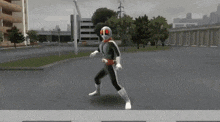 a man in a superhero costume is standing on a street