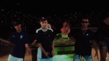 a group of young men are dancing in front of a pool table