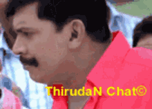 a man in a red shirt with the words thiruda n chat written on it