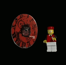 a lego figure standing next to a cd that says happy season