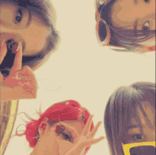 a group of women are posing for a picture and one of them has red hair