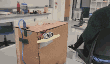 a cardboard box with a remote control on it