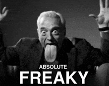 a black and white photo of a man sticking out his tongue with the words absolute freaky behind him