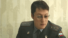 a man in a military uniform has a patch on his arm that says ' russia ' on it