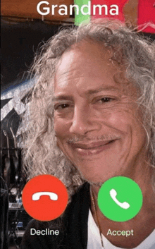a man with curly hair is talking to his grandma on a cell phone