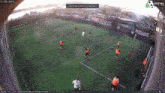 a group of soccer players are playing on a field sponsored by sosyal.com