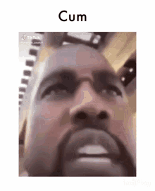 a close up of a man 's face with the words cum written on the bottom .