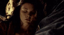 a woman is sleeping with her eyes closed