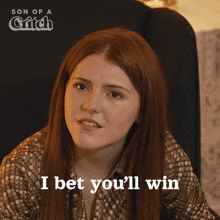 a woman says i bet you 'll win in front of a poster for son of a grifch