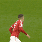 a soccer player in a red jersey with the number 7 on it