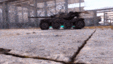 a large military vehicle is driving on a cracked concrete surface