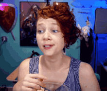 a woman with red hair is holding a bowl of food