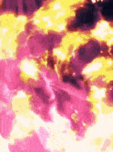 a close up of a pink and yellow background with a blurred effect .