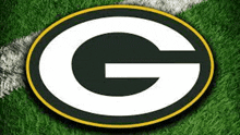 a green bay packers logo is on a green grass field