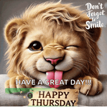 a picture of a lion with its tongue sticking out and a happy thursday message