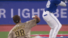 a baseball player wearing a number 98 jersey is throwing the ball