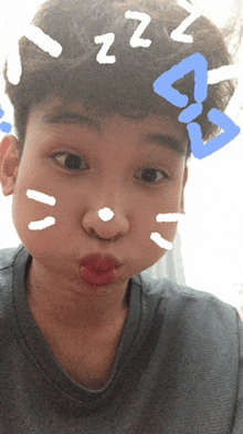 a young boy making a funny face with zzz written on his hair