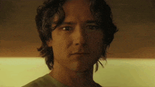 a close up of a man 's face looking at the camera