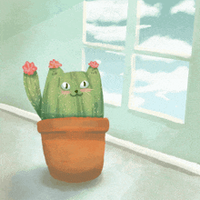 a cat shaped cactus in a pot with flowers