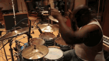a man playing drums with a cymbal that says imax on it