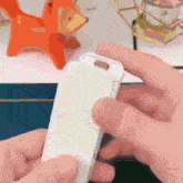 a person is holding a white object in their hands