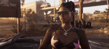 a woman wearing sunglasses and a necklace with the letter bc