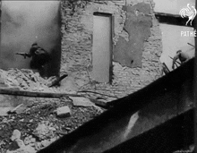 a black and white photo of a building with pathe written on the bottom left