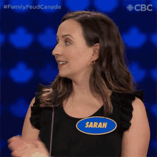 a woman wearing a name tag that says sarah on it