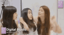 three girls are standing next to each other in a digital studio