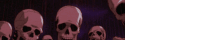 a group of skulls are standing next to each other on a purple background .