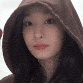 a close up of a woman wearing a hooded jacket