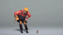 a man in overalls and a hard hat stands next to a small orange bird