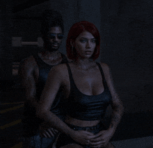 a man and a woman pose for a picture in a dark room