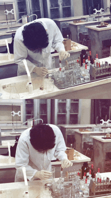 a man in a lab coat is pouring liquid into a beaker